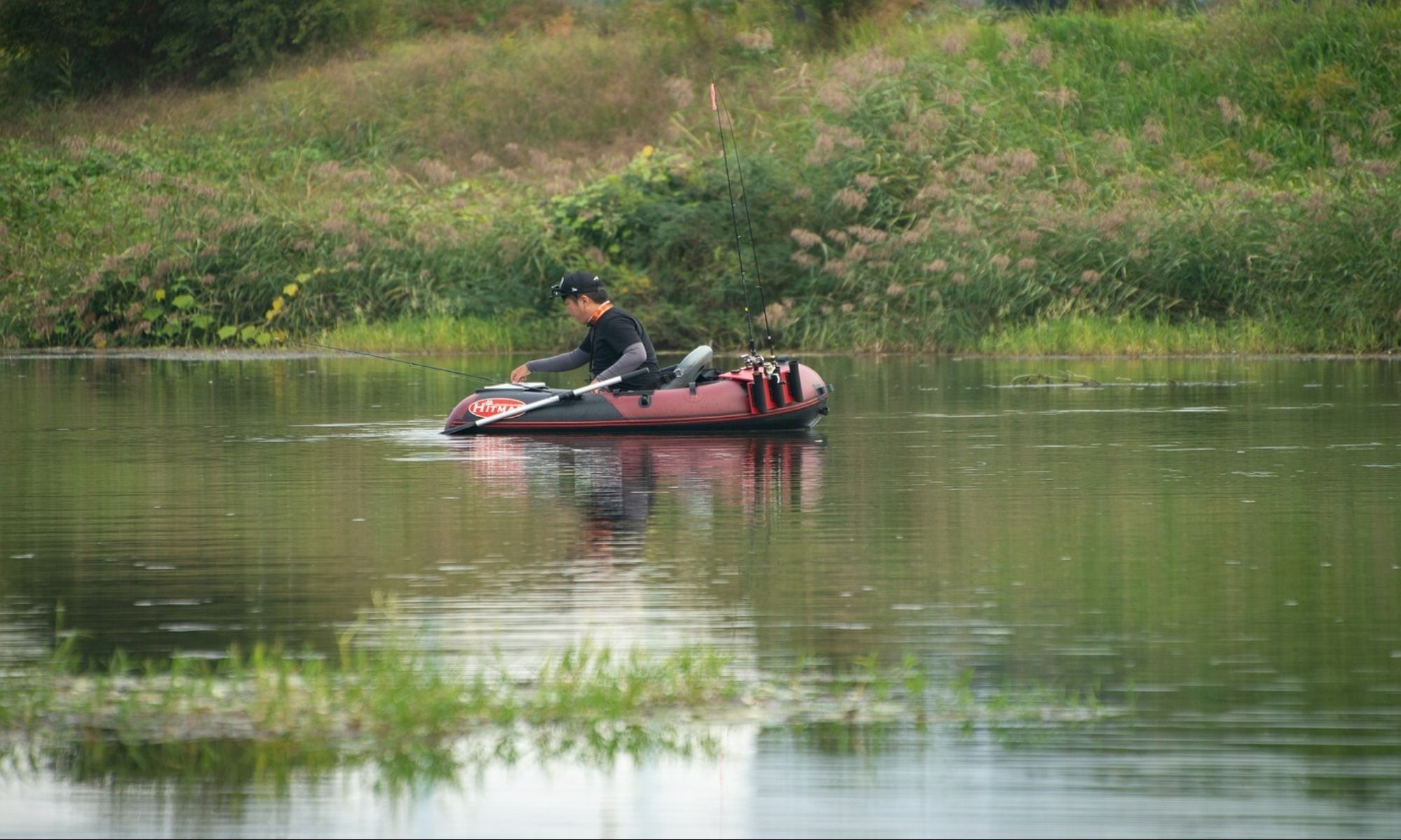 man on a belly boat fishing on the river