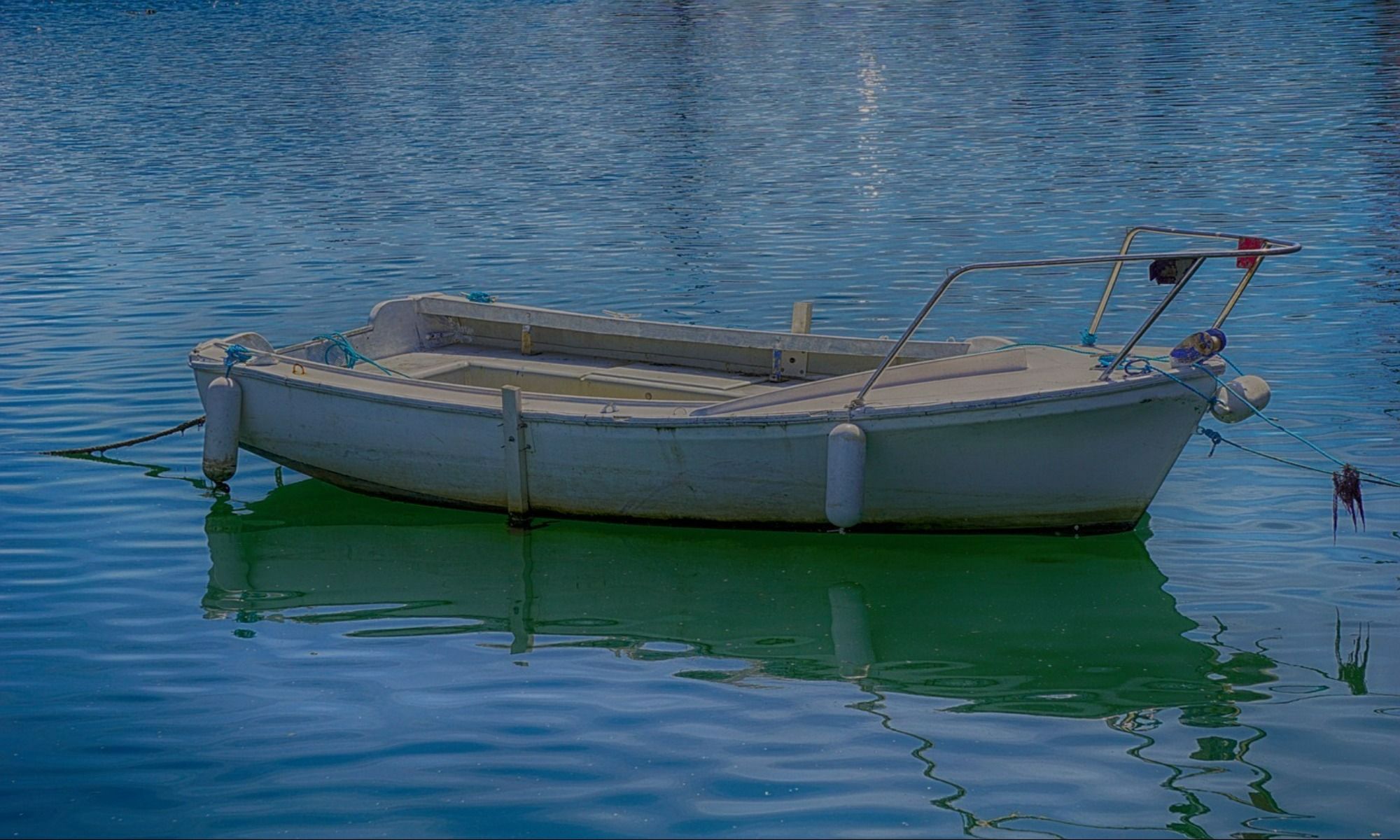 white fishing boat on a lake