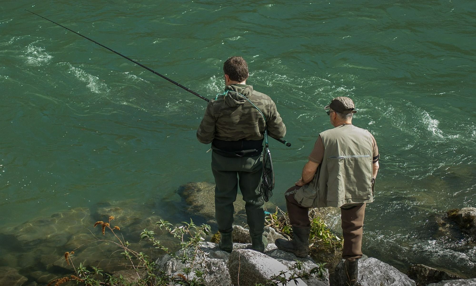 two men fishing by the lake