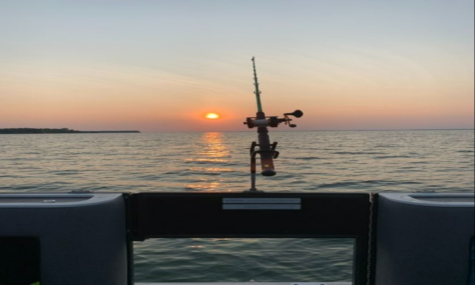 fishing rod on a boat at sunset