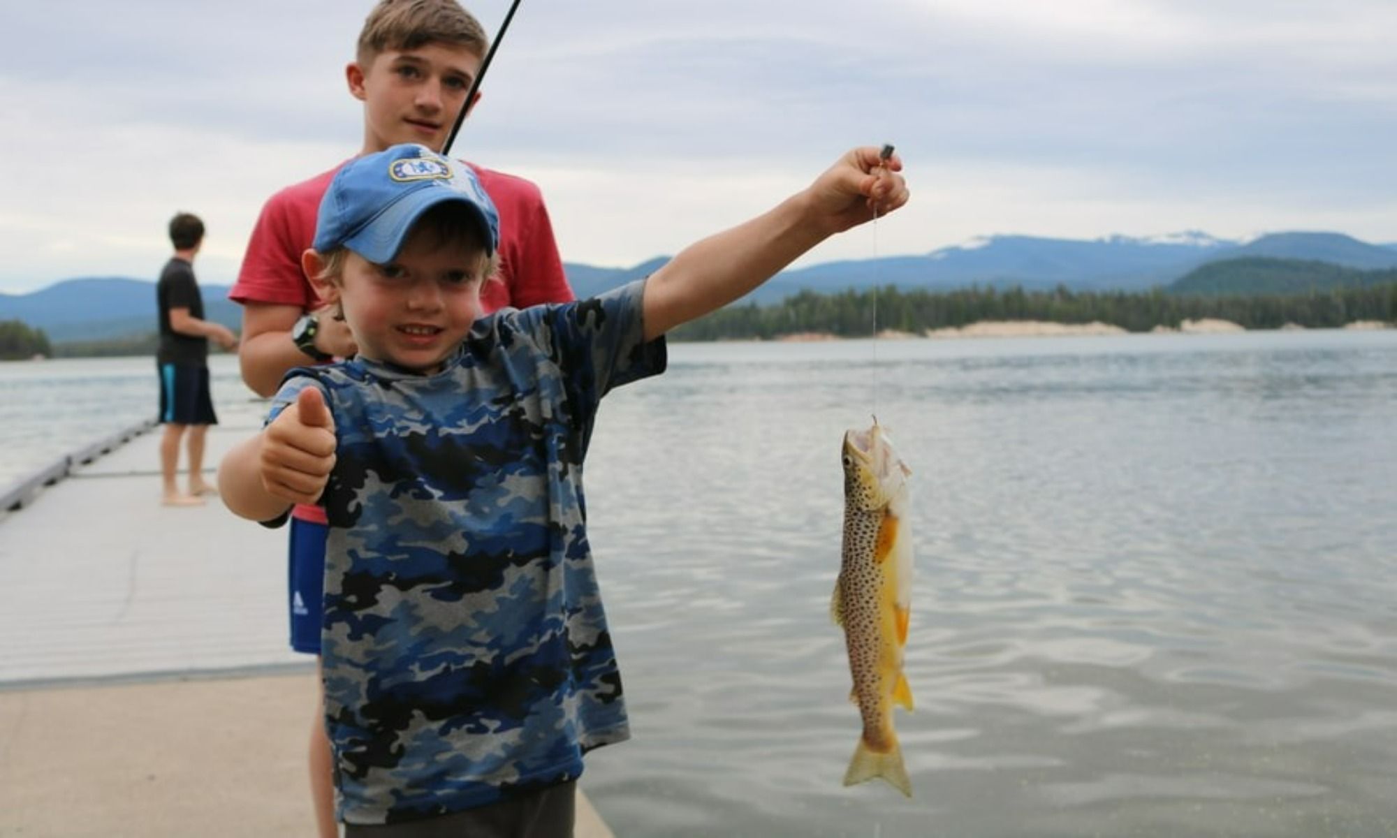 kids fishing by the lake